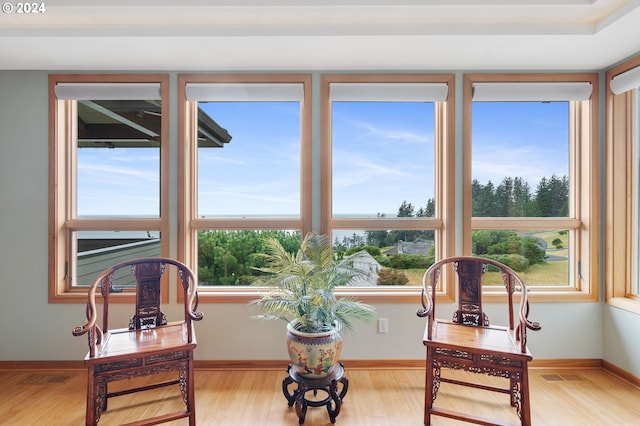 sitting room featuring baseboards, visible vents, and light wood-style floors