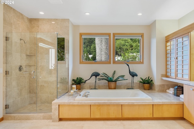 bathroom featuring tile patterned flooring and independent shower and bath