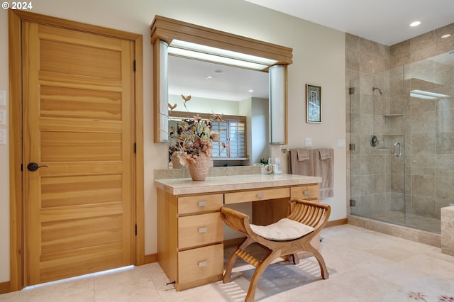 bathroom featuring tile patterned flooring, a shower stall, vanity, and baseboards