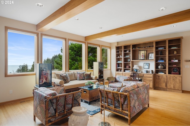 living area featuring recessed lighting, beamed ceiling, light wood finished floors, and baseboards