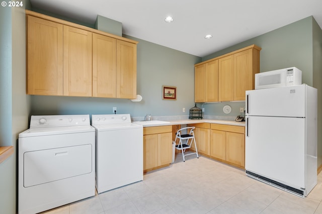 washroom with washing machine and dryer, cabinet space, a sink, and recessed lighting