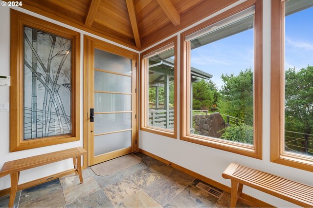 unfurnished sunroom with wood ceiling, beam ceiling, and radiator heating unit