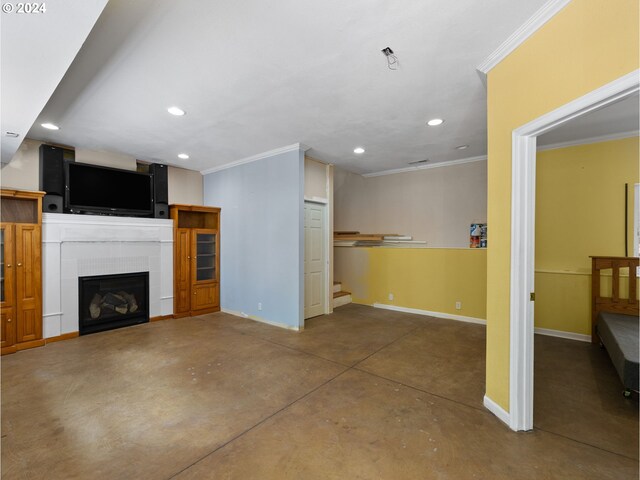 unfurnished living room with a tiled fireplace, concrete flooring, and ornamental molding