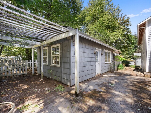 view of outbuilding featuring a pergola