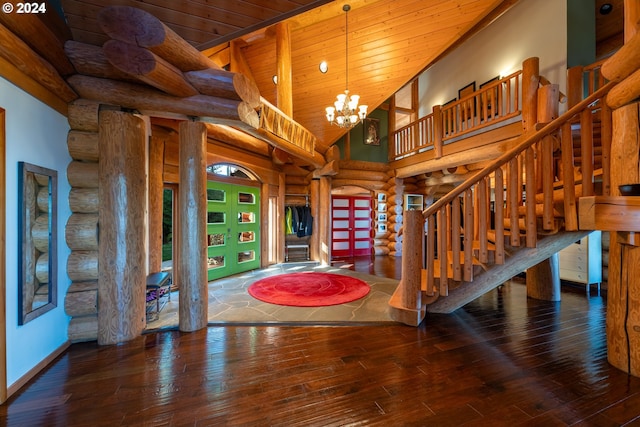 foyer entrance with wood ceiling, rustic walls, high vaulted ceiling, an inviting chandelier, and dark hardwood / wood-style flooring