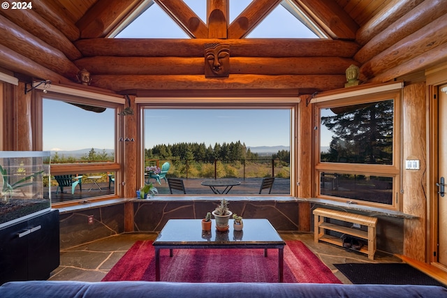 living room with vaulted ceiling with beams and log walls