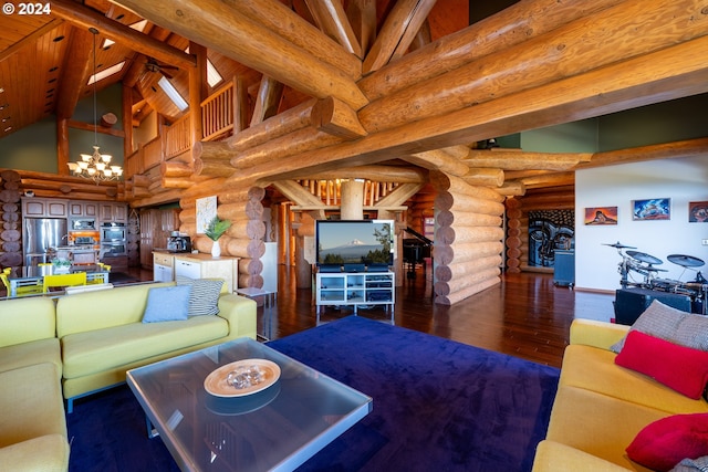 living room with dark hardwood / wood-style floors, a chandelier, rustic walls, and high vaulted ceiling