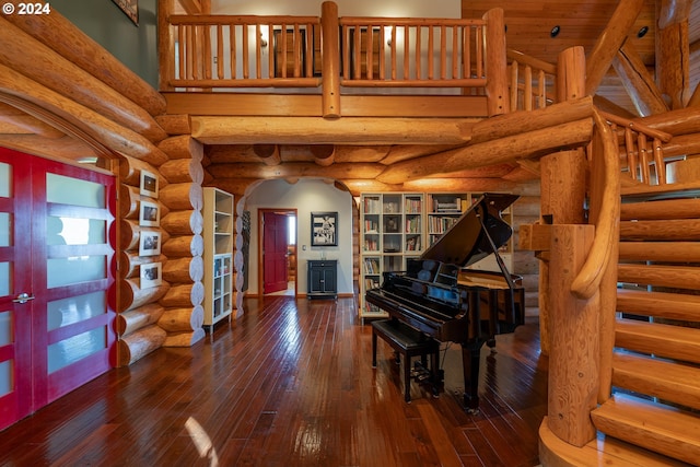 interior space featuring french doors, dark wood-type flooring, and log walls