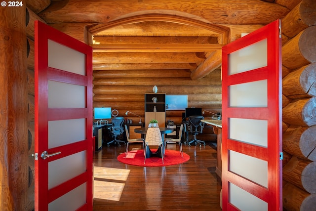 office space with beamed ceiling, log walls, and dark wood-type flooring