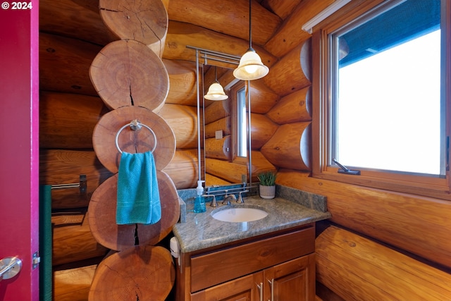 bathroom featuring vanity and rustic walls