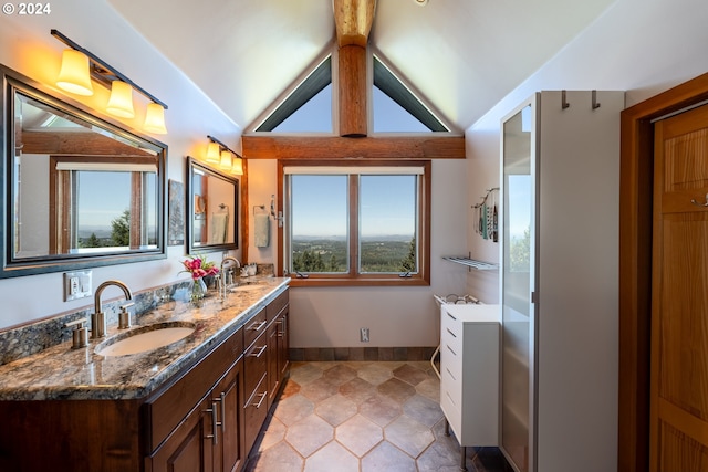 bathroom featuring vanity, tile patterned flooring, vaulted ceiling, and a healthy amount of sunlight