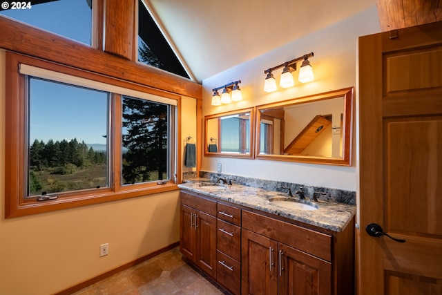 bathroom with vanity, lofted ceiling, and tile patterned floors