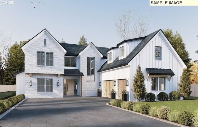 view of front of property with decorative driveway, brick siding, board and batten siding, a front yard, and fence