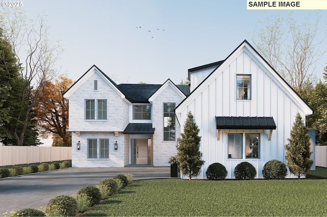 view of front of home featuring board and batten siding, a standing seam roof, metal roof, and driveway