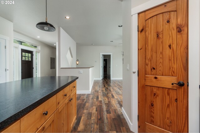 kitchen featuring decorative light fixtures and dark wood-type flooring