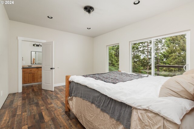 bedroom featuring sink, ensuite bathroom, and dark hardwood / wood-style floors