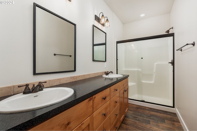 bathroom with an enclosed shower, vanity, and hardwood / wood-style floors