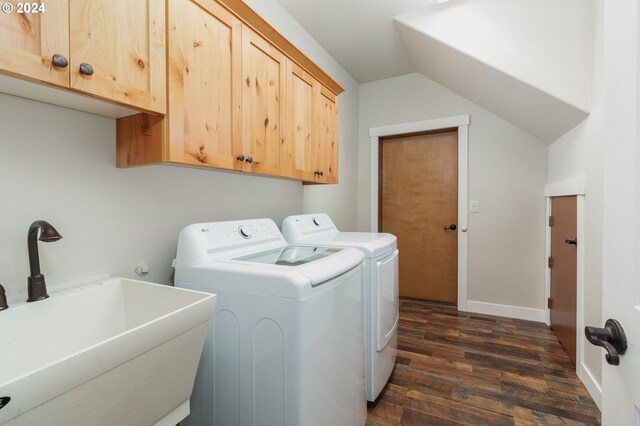 clothes washing area featuring sink, washing machine and dryer, cabinets, and dark wood-type flooring