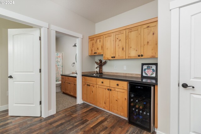 kitchen featuring wine cooler, dark wood-type flooring, and sink