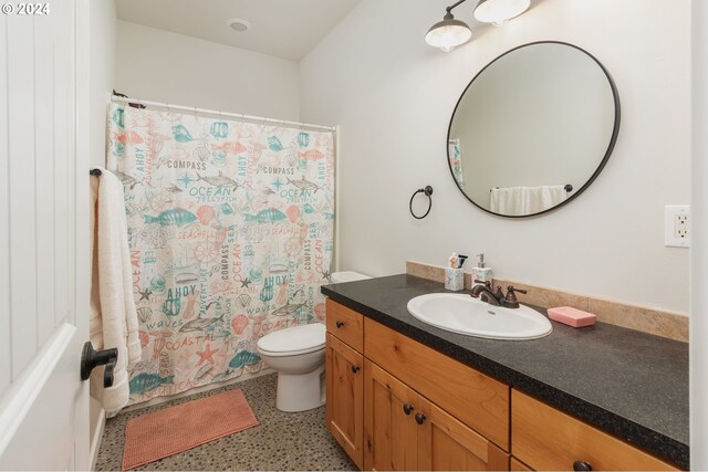 bathroom with toilet, vanity, a shower with curtain, and tile patterned floors