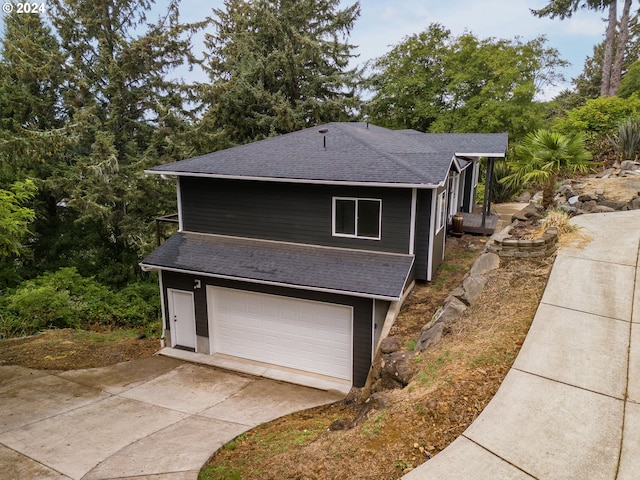 view of side of home with a shingled roof