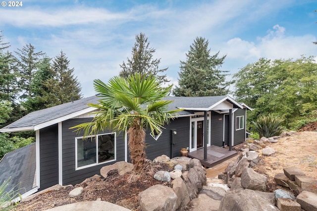 exterior space with roof with shingles