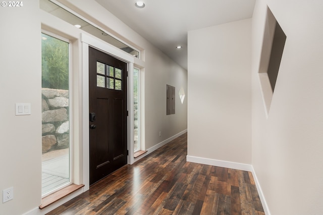 entryway featuring dark wood-style floors, electric panel, and baseboards