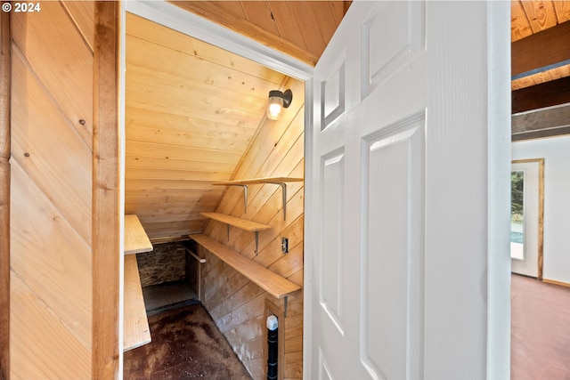 stairway with a sauna, wood walls, and wooden ceiling