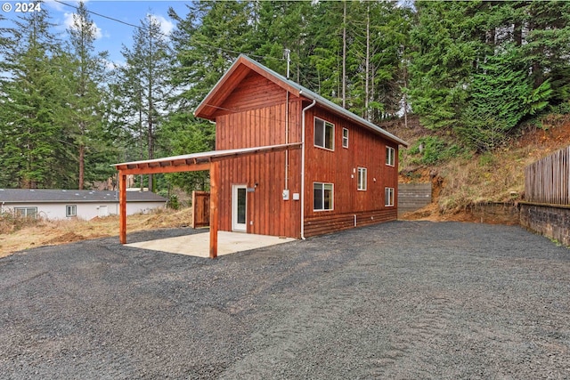 exterior space featuring a carport and fence