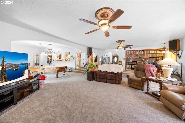 carpeted living room with ceiling fan with notable chandelier, a textured ceiling, and pool table