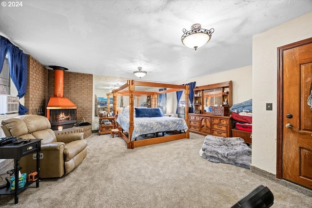 bedroom with carpet flooring, a wood stove, and a textured ceiling