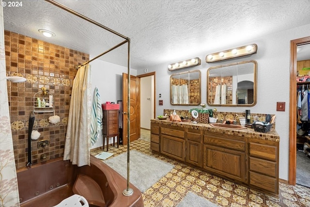 bathroom with vanity, shower / bath combo, and a textured ceiling