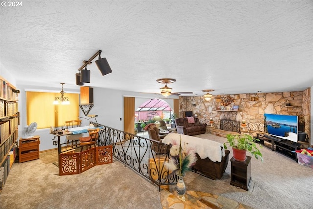 carpeted living room featuring a fireplace, a textured ceiling, and ceiling fan with notable chandelier