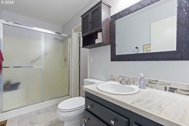 bathroom with vanity, toilet, and an enclosed shower