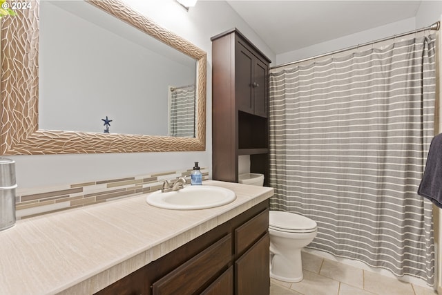 bathroom with tile patterned floors, vanity, toilet, and backsplash