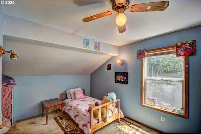 carpeted bedroom with ceiling fan and vaulted ceiling