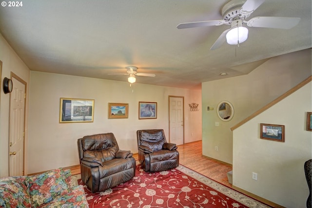 living room with light wood-type flooring and ceiling fan