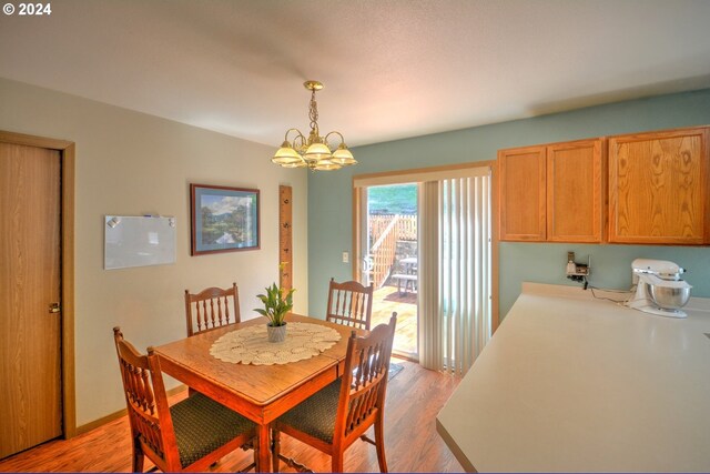 dining room with a chandelier and light hardwood / wood-style floors