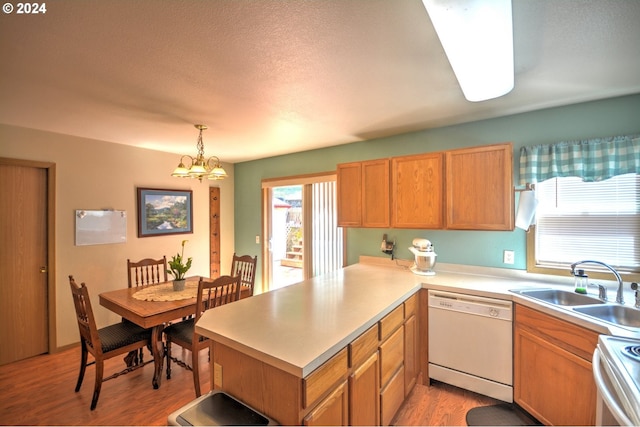 kitchen featuring sink, white appliances, light hardwood / wood-style flooring, an inviting chandelier, and decorative light fixtures