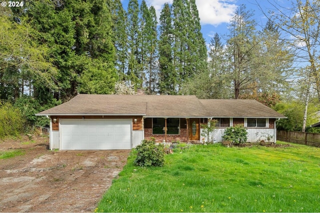 view of front of house with a garage and a front lawn