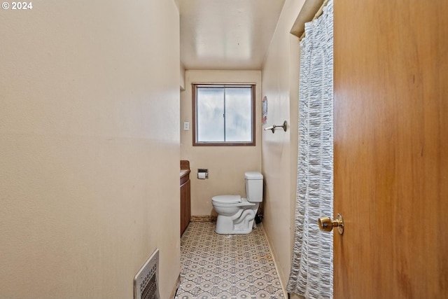 bathroom with toilet and vanity