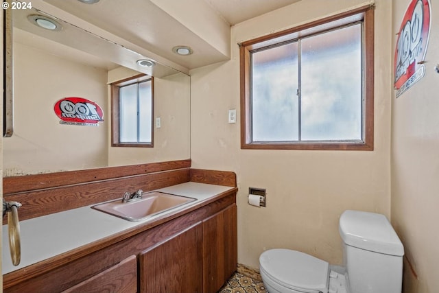 bathroom with toilet and vanity