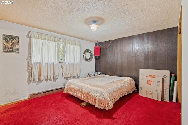 bedroom featuring a textured ceiling, a baseboard heating unit, and wood walls