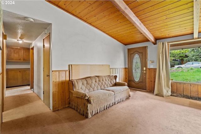 sitting room featuring wooden ceiling, wood walls, and vaulted ceiling with beams