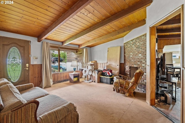 living area with lofted ceiling with beams, wood ceiling, and wooden walls