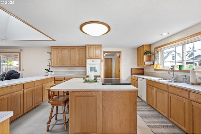 970 Kalmia St, Junction City, OR 97448 - kitchen with white appliances, open shelves, a kitchen bar, a center island, and light countertops