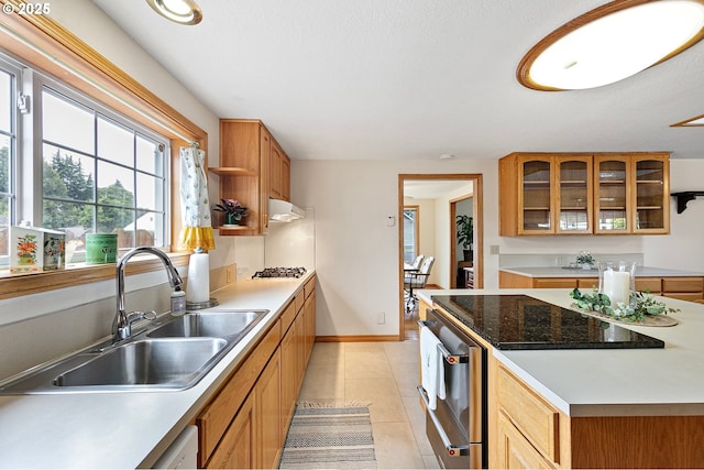 970 Kalmia St, Junction City, OR 97448 - kitchen with glass insert cabinets, light tile patterned floors, brown cabinets, range hood, and light countertops