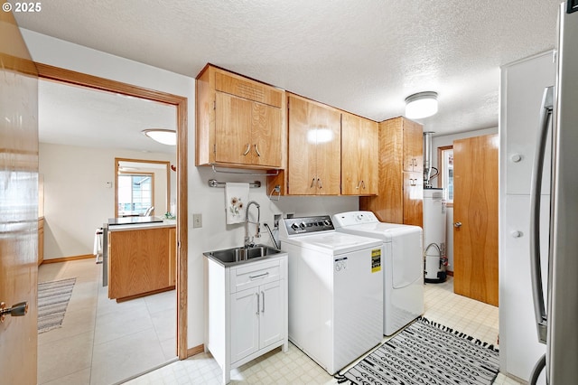 970 Kalmia St, Junction City, OR 97448 - laundry area with washer and clothes dryer, cabinet space, water heater, and a textured ceiling