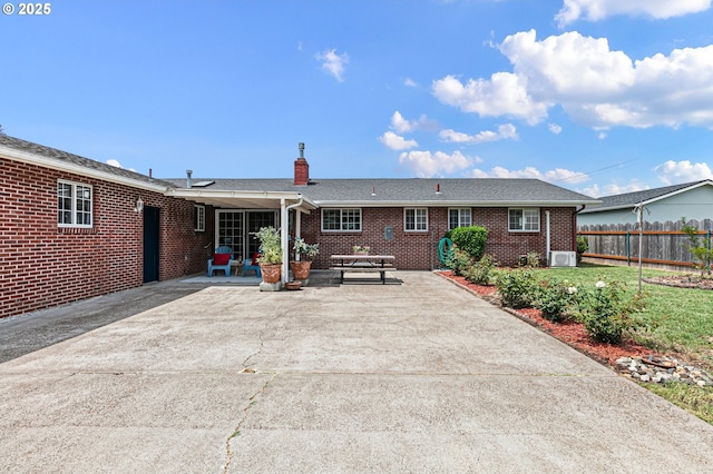970 Kalmia St, Junction City, OR 97448 - rear view of house with a chimney, a patio area, and brick siding