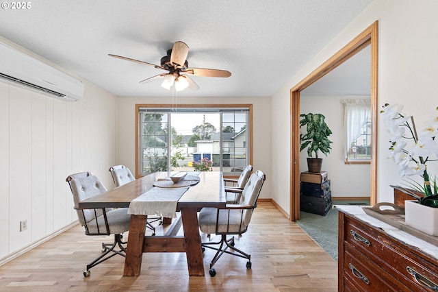 970 Kalmia St, Junction City, OR 97448 - dining area featuring an AC wall unit, light wood-type flooring, and a ceiling fan